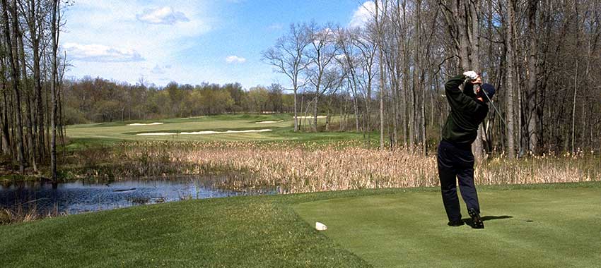 A golfer teeing off Lyon Oaks Golf Course
