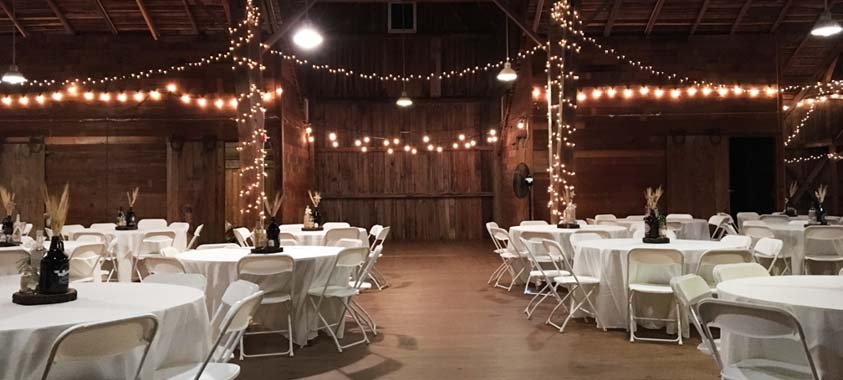 Ellis Barn setting for dinner gathering tables and chairs.