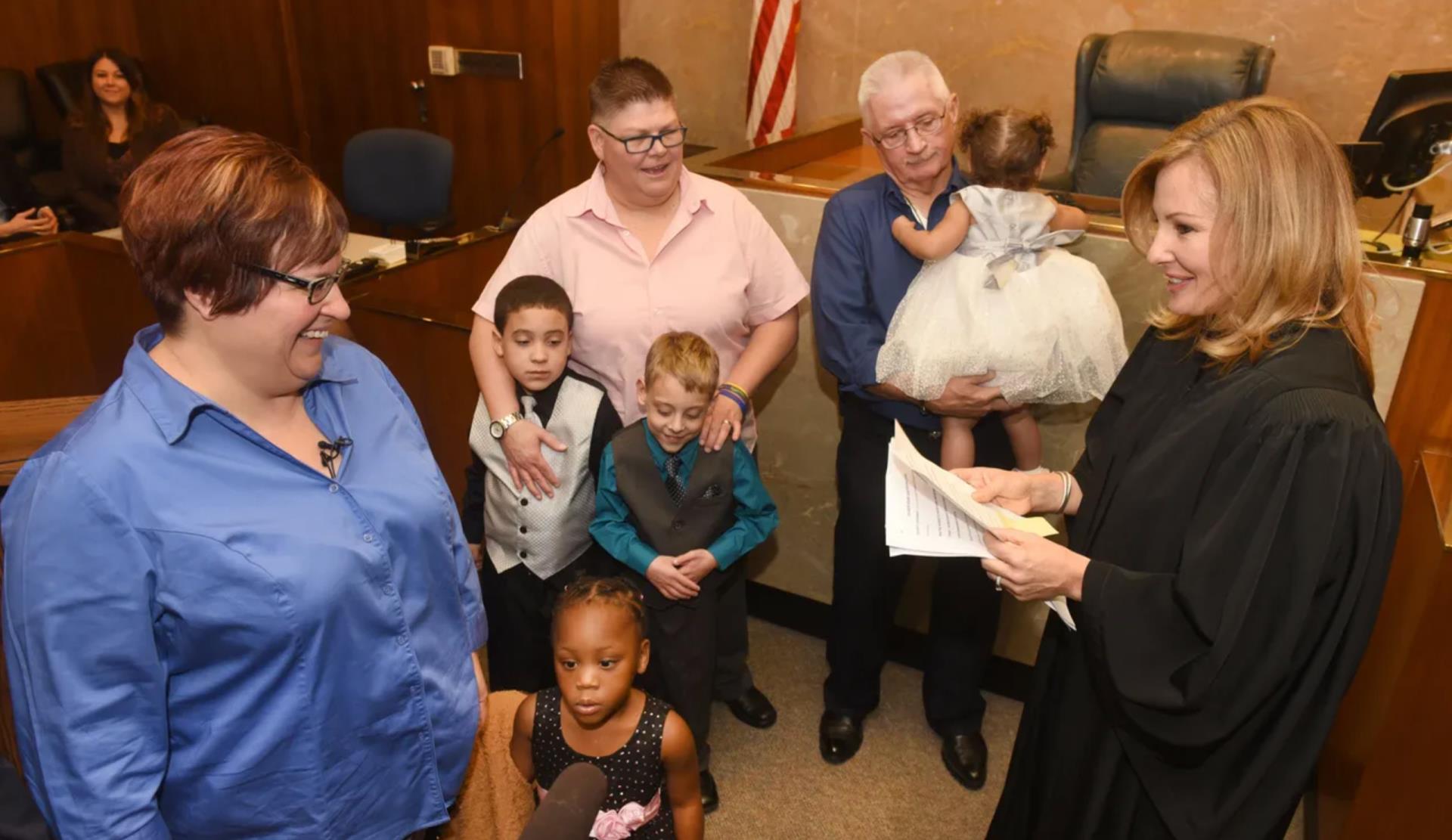 Karen McDonald with families and their adopted children